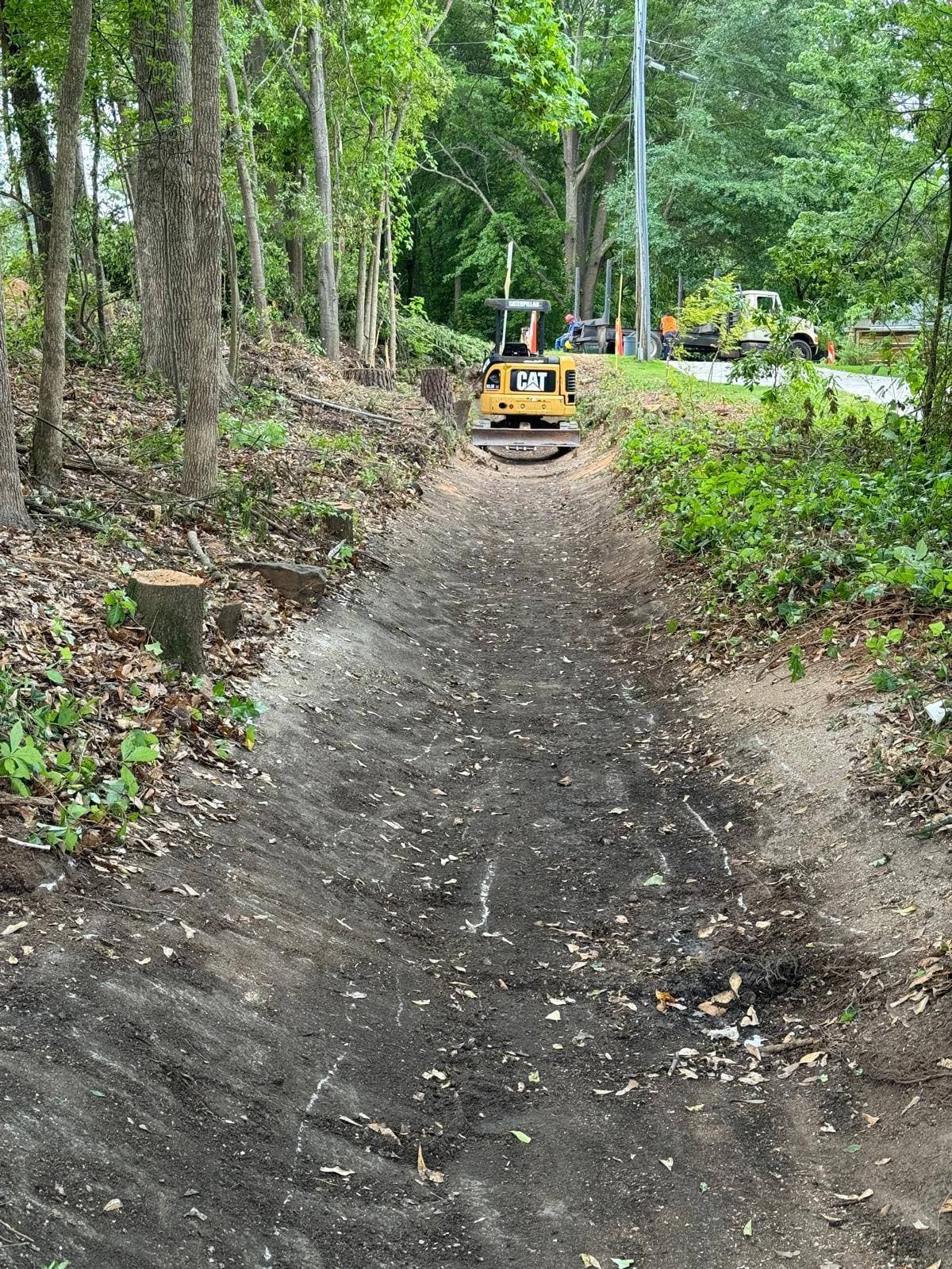 Before — raw dirt path, land clearing and excavation starting point